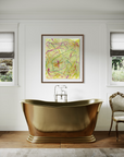 Brass tub with a chair next to it and two windows on each side. Colorful abstract artwork hangs above the tub