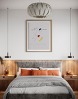 Modern bedroom with a bed, nightstands, and abstract art on the wall.