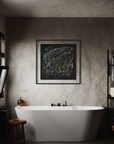 A framed abstract black painting with colorful scribbled lines hangs on a textured plaster wall above a white freestanding bathtub in a moody bathroom setting.