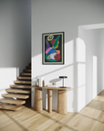 Modern interior with a staircase, wooden table, and colorful abstract painting on a white wall.