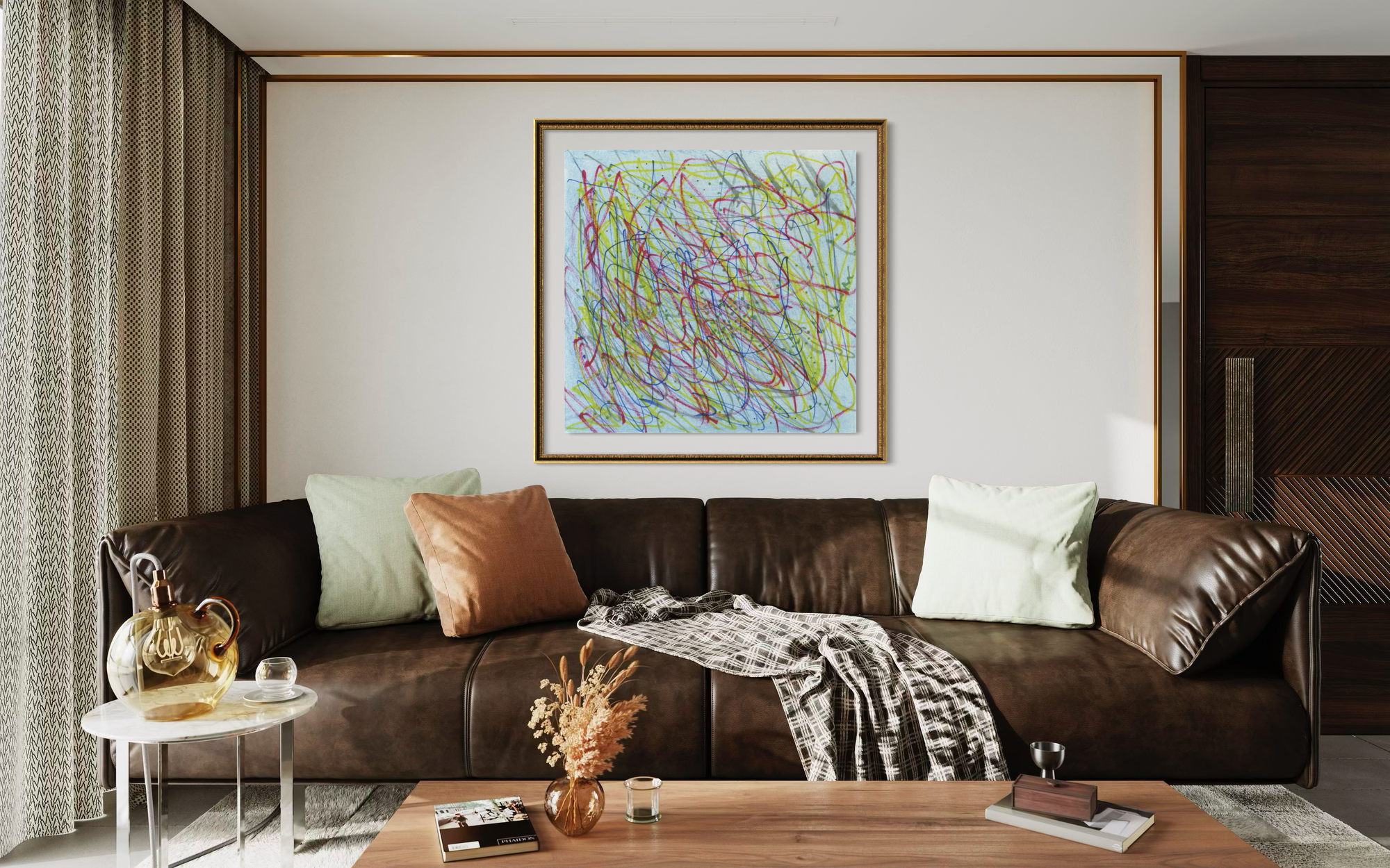 A framed abstract art print with multicolored scribbled lines hangs on a white wall above a brown leather sofa in a modern living room setting.