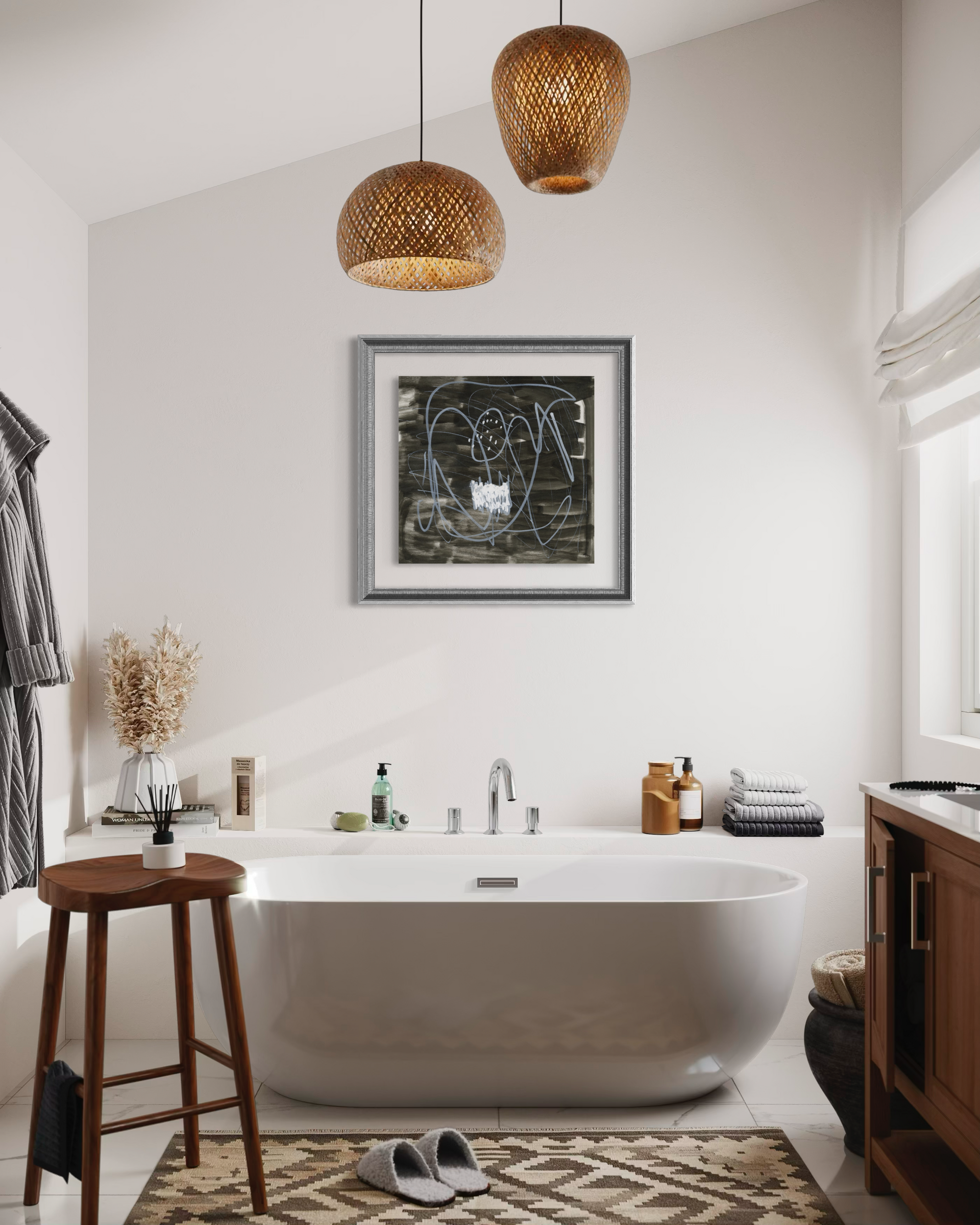 A modern bathroom interior featuring a freestanding oval bathtub centered beneath a framed abstract print on a white wall. Two woven pendant lights hang above, with a wooden stool, patterned rug, toiletries, and a window visible in the room.