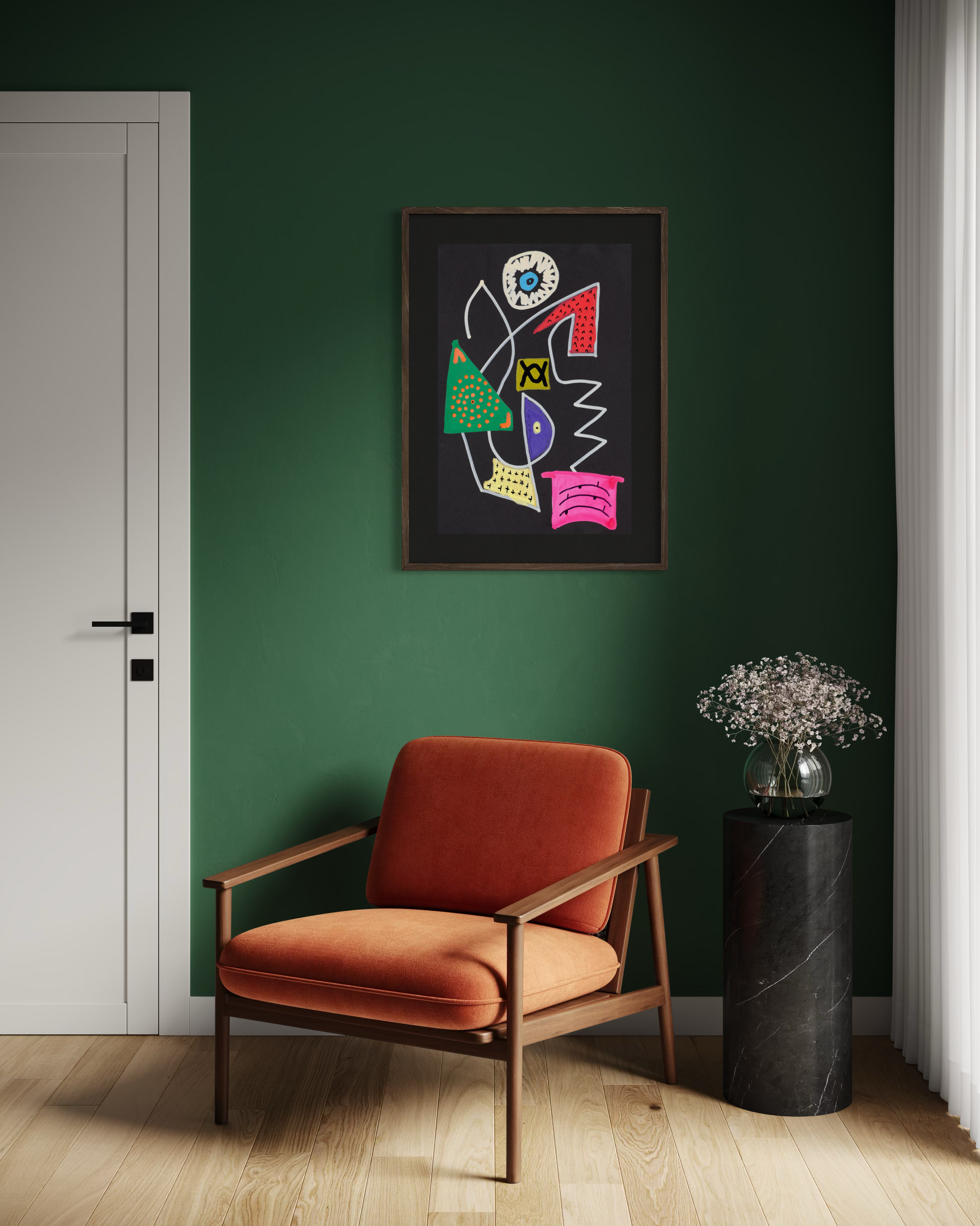 A framed abstract art print with colorful geometric shapes hangs on a dark green wall above a rust-orange armchair, next to a black marble side table with a vase of flowers.