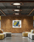 Expansive lobby with grey and yellow seating with a copper colored will displaying colorful abstract artwork
