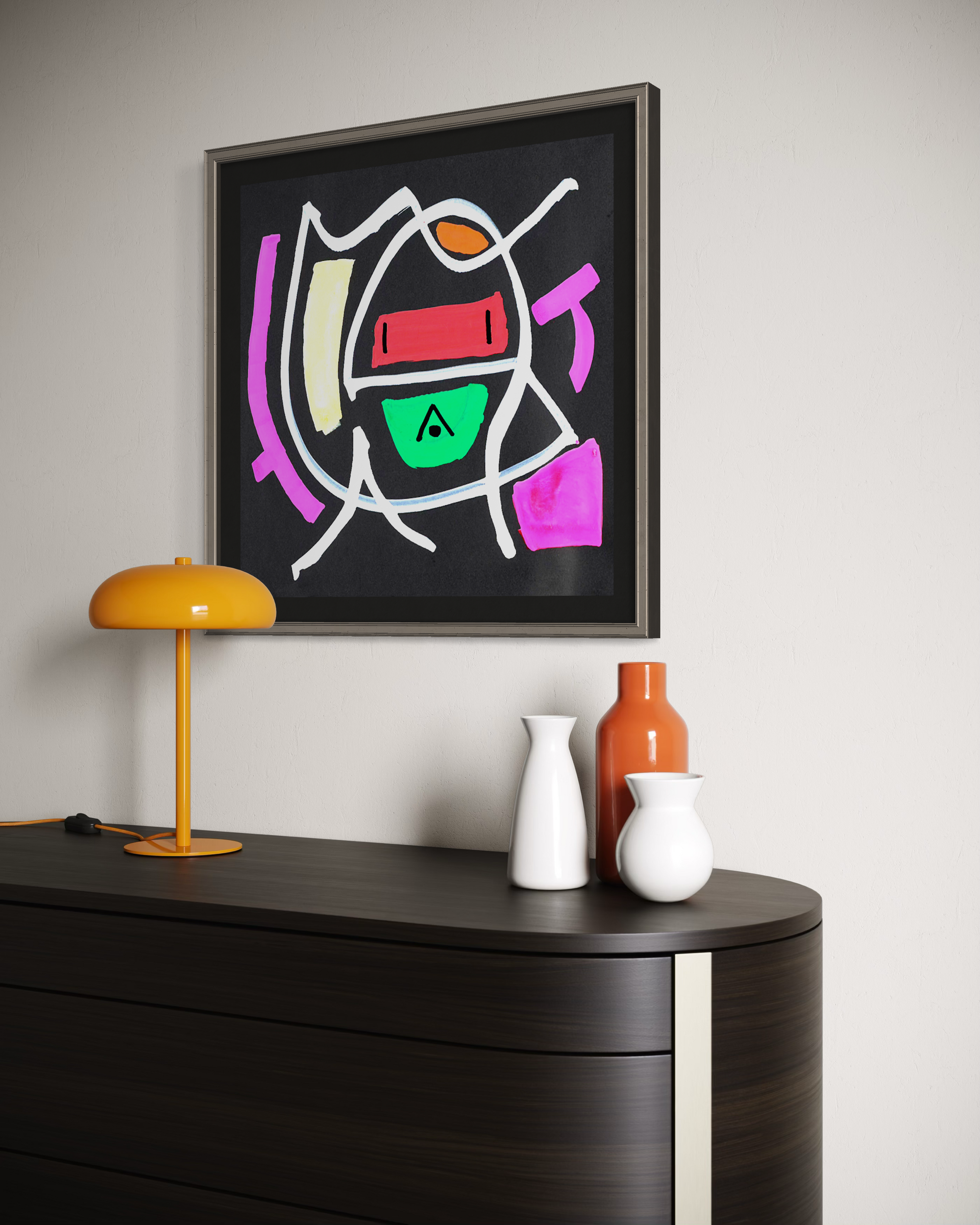 A framed abstract geometric wall art print hangs on a light gray wall above a dark wood console table. The artwork features bold, colorful shapes on a black background, including pink, green, orange, red, and white.