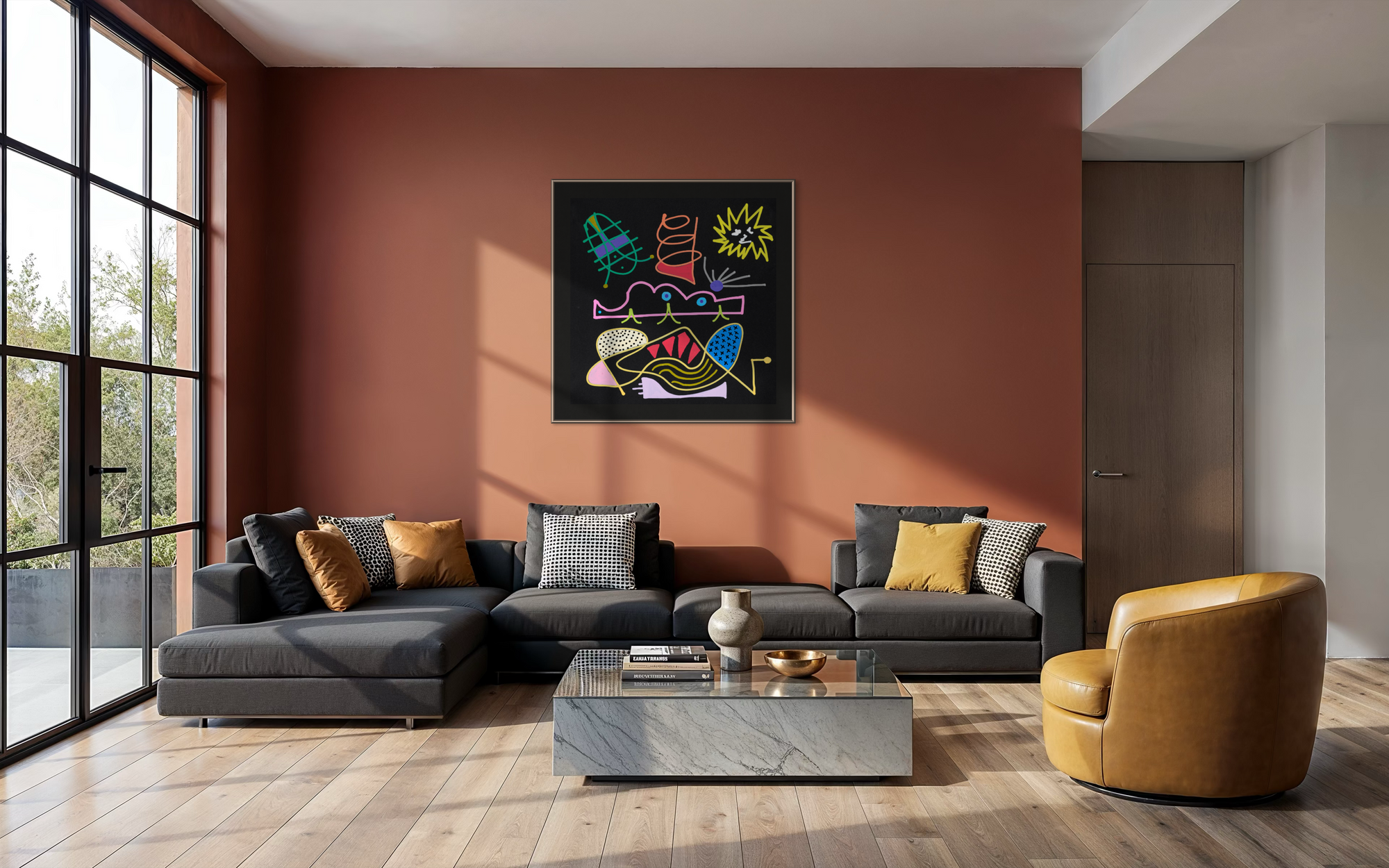 A modern living room with a terracotta accent wall featuring a colorful abstract canvas print. Below the artwork is a dark gray sectional sofa with accent pillows, a marble coffee table, and a mustard yellow leather armchair.