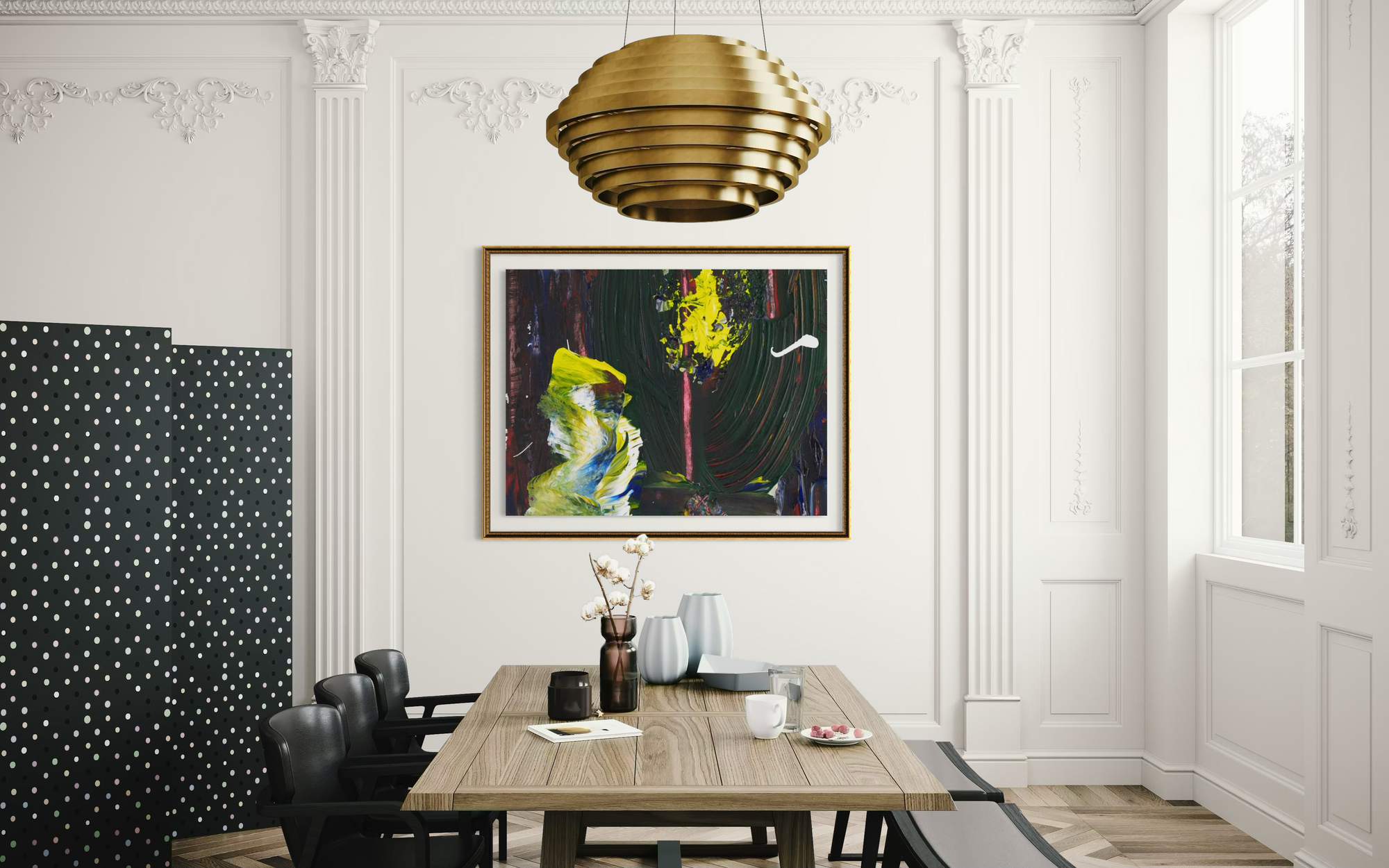 A framed abstract painting hangs on a white paneled wall in a dining room setting. The painting features bold brushstrokes in black, green, yellow, and blue.
