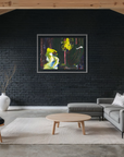 A framed abstract painting with vibrant yellow, green, and blue brushstrokes hangs on a black brick wall in a modern living room with a gray sectional sofa, wooden chair, and exposed wood beams.