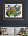 Off white couch with pillows and lamps on end tables against a dark grey background with abstract art hanging on the wall