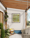 Outdoor patio with a hanging macrame chair in one corner, a rocking chair next to the entrance to the house, plants in the foreground and a colorful piece of abstract artwork