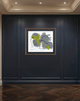 A framed abstract wall art print hangs on a dark navy paneled hallway wall, flanked by gold wall sconces and a wood herringbone floor.