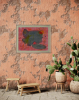 A Southwestern room with dark salmon colored walls with two benches, two cacti and an abstract painting on wall